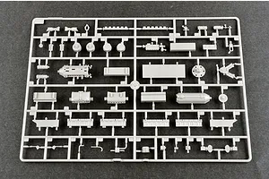 A grey plastic model kit sprue containing various small parts for a 1/35 scale military vehicle model, laid out on a dark grey surface.