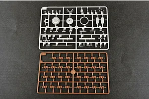Two plastic model kit sprues from a Trumpeter 1/35 scale military vehicle kit, one grey and one brown, laid out on a dark grey surface.