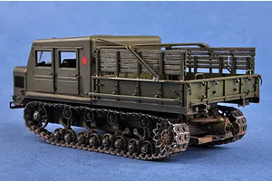 A 1/35 scale plastic model of a Russian AT-S artillery tractor painted in olive green with a red star emblem on the side.