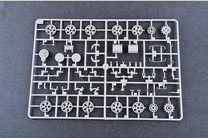 A grey plastic model kit sprue containing various tank wheels, suspension parts, and small components for a 1/35 scale model.