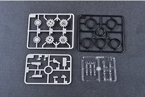 Four plastic model kit sprues including grey, black, and clear parts for a T-62 tank model.