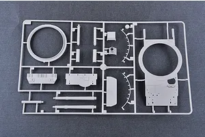 A grey plastic model kit sprue containing various tank parts, including a turret ring and hull components, against a dark grey background.