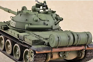 A detailed 1/35 scale model of a Russian T-62 tank painted in olive green, featuring a turret with the number 720 and rear-mounted fuel drums.