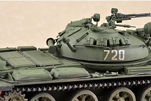 A close-up view of a 1/35 scale model of a Russian T-62 tank, showing the turret, hull, and tracks painted in olive green with the number 720 on the side.