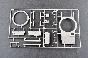 A grey plastic model kit sprue containing tank turret and hull components for a 1/35 scale model.