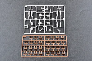 Two plastic model kit sprues on a grey background, one white with figure parts and one brown with small track or suspension components.