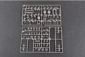 Two grey plastic model kit sprues containing various small tank parts laid out on a dark grey surface.