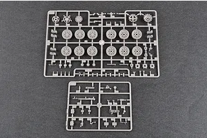 Two grey plastic model kit sprues containing tank wheels, sprockets, and small mechanical parts on a dark grey background.