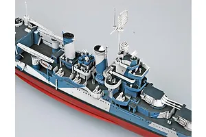 A high-angle view of a detailed 1/350 scale model of the USS San Francisco heavy cruiser, showing its blue and white camouflage deck and superstructure.