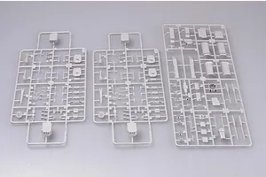 Three grey plastic model kit sprues containing various ship parts laid out on a plain light grey background.