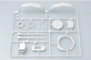 A light grey plastic model kit sprue containing various parts for a military vehicle model, including gun barrels, turret rings, and curved armor plates.