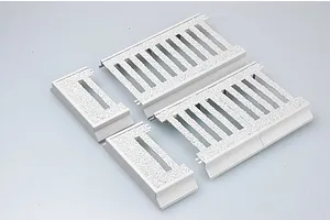 Four grey plastic model kit parts for a 1/35 scale armoured train on a white background.