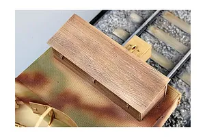 Top-down view of a 1/35 scale model armoured train carriage featuring a wooden roof section and camouflage plating on a model railway track.