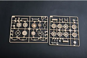 Two tan plastic model kit sprues containing various wheel and suspension parts for a 1/35 scale military vehicle model.