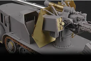 A partially assembled 1/35 scale plastic model of a German 8.8cm Flak 18 half-track, showing grey plastic parts and brass photo-etched metal details.