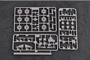 Three grey plastic model kit sprues containing tank wheels and small mechanical parts on a dark textured background.