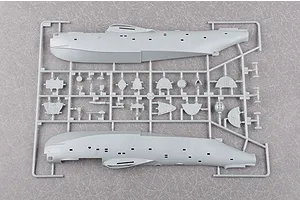A grey plastic sprue from a Trumpeter 1/72 scale Be-6 Madge model kit, showing the two main fuselage halves and various smaller interior components.