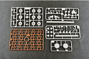 Four plastic model kit sprues for a 1/35 scale tank, including grey and brown parts on a dark grey surface.