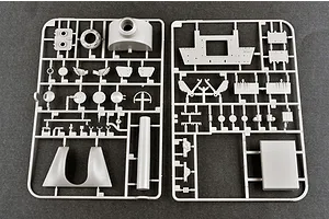 Two grey plastic model kit sprues containing various vehicle parts laid out on a dark surface.