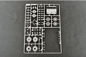 A grey plastic model kit sprue containing various tank parts, including wheels, sprockets, and structural components, on a dark grey background.