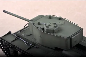 A high-angle close-up of a 1/35 scale Russian KV-220 tank model, showing the turret, main gun, and upper hull details in olive green.