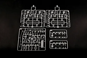 Five grey plastic model kit sprues containing various small parts for a 1/35 scale military vehicle model, laid out on a black background.