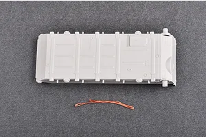 A grey plastic tank hull part and a small piece of copper wire from a Trumpeter 1/35 scale model kit.