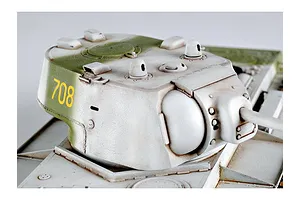 Close-up of a painted KV-1 tank model turret with white winter camouflage and the number 708 in yellow on the side.