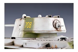 Close-up of a painted scale model KV-1 tank turret with number 708 in yellow, featuring weathered white and green camouflage.