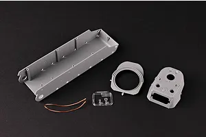 Unassembled plastic model tank parts including the hull, turret, clear parts, and a copper wire on a black background.
