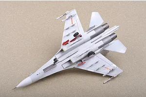 A high-angle view of a completed 1/72 scale plastic model of a Russian Su-30MKK fighter jet, showing the underside with landing gear and missiles.