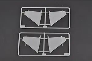 Two grey plastic model kit sprues containing aircraft wing parts on a dark grey background.