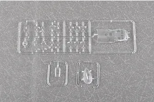 Clear plastic model kit sprues for a Trumpeter aircraft model, showing canopy and small cockpit parts on a grey textured background.