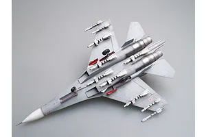 A fully assembled and painted 1/72 scale model of a Russian Su-27UB fighter jet, viewed from the underside against a plain grey background.