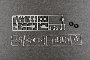 Plastic model kit sprues for a Trumpeter 1/48 scale aircraft model, including grey plastic parts, clear canopy parts, and two black rubber tires.