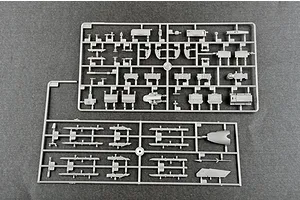 Two grey plastic model kit sprues containing various aircraft parts, including missile rails and structural components, on a dark grey background.