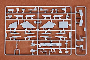A grey plastic sprue containing various aircraft model parts for a Trumpeter 1/72 scale RA-5C Vigilante kit, laid out on a brown surface.