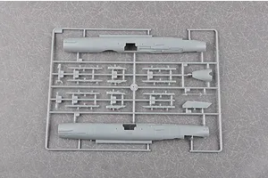 A grey plastic sprue from a Trumpeter 1/48 scale J-7G model kit, featuring two fuselage halves and various small aircraft components.