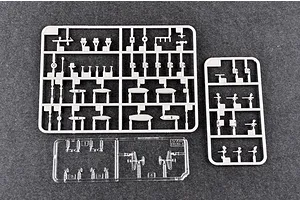Three plastic model kit sprues for a 1/700 scale battleship, including grey plastic parts and a clear plastic sprue on a dark grey surface.