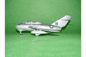 A side view of a silver MiG-15 UTI model aircraft with Pakistani Air Force markings, displayed on a green background.