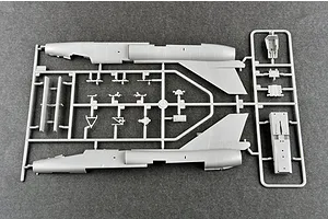 A grey plastic model kit sprue containing fuselage halves and small aircraft components for a 1/72 scale model jet.