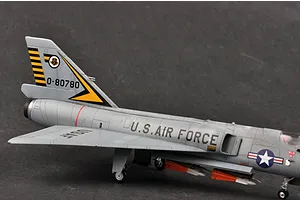 A side view of a 1/72 scale plastic model of an F-106A Delta Dart fighter jet, painted in grey with US Air Force markings and yellow tail stripes.