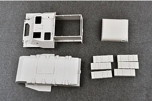 Unassembled grey plastic model kit parts for a 1/35 scale Soviet AT-P artillery tractor, including the main hull and roof sections.