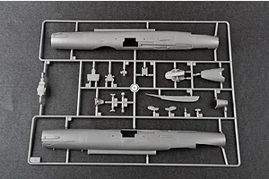 A grey plastic sprue containing model aircraft fuselage halves and various small components for the Trumpeter 1/48 J-7A fighter jet model kit.