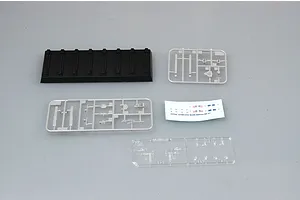 Components of the Trumpeter 1/700 USS South Dakota BB-57 model kit, including a black display stand, grey plastic sprues, a clear sprue, and a decal sheet.