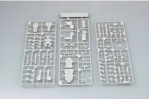 Three grey plastic model kit sprues containing various ship parts laid out on a plain grey surface.