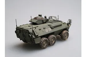 A 1/35 scale model of a Canadian Grizzly AVGP armoured vehicle, painted in olive drab with SFOR markings, viewed from the rear three-quarter angle.