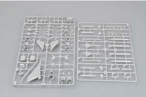 Two grey plastic model kit sprues containing various aircraft parts, including wings, missiles, and fuselage components, laid out on a plain grey background.