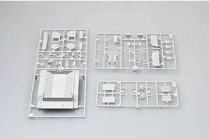 Three grey plastic model kit sprues containing various vehicle parts for a 1/35 scale military truck model.