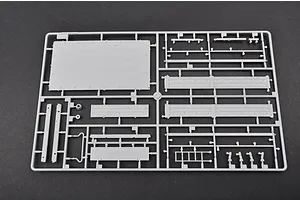 A grey plastic model kit sprue containing various flat panels and structural components for a 1/35 scale military vehicle model.